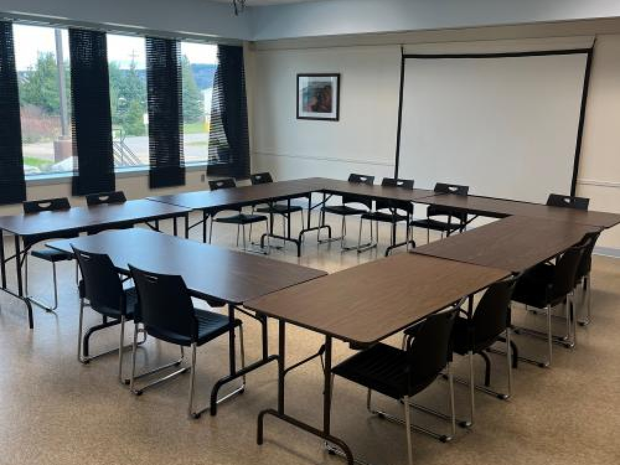 multi-purpose room at the Fundy Geological Museum, a wall of windows, tables and chairs.